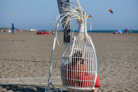 Ulcinj,Montenegro - July 23, 2017:Girl sitting in the swing on the beachのeditorial素材