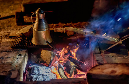 Coffee making on a wood fire at open placeの写真素材