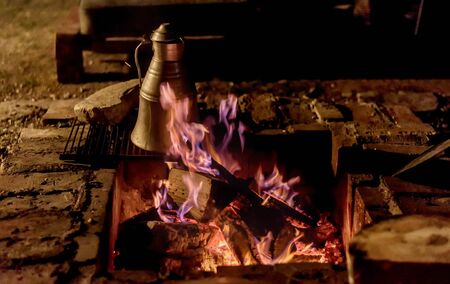 Coffee making on a wood fire at open placeの写真素材