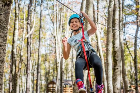 Beautiful little girl having fun in adventure Park, Montenegroの写真素材