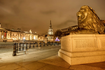 London, UK- January 12, 2018: Lion Statue at Trafalgar Square at night  in London, UKのeditorial素材