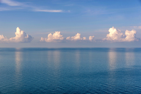 White clouds above tranquil ocean waterの写真素材
