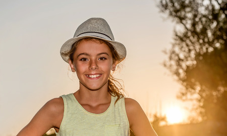 Portrait of a beautiful young girl in a summer hatの写真素材