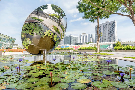 Singapore, Singapore- February 28, 2018:Pond with lotus flowers near Museum of Fine Arts on business district Marina Bay Sands, Singaporeのeditorial素材