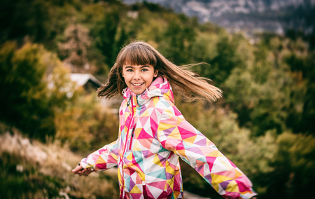 Portrait of a beautiful carefree young girl playing with her hairの写真素材