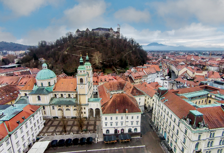 Aerial view of castle in Ljubljana, Slovenia surrouded by buildingsのeditorial素材