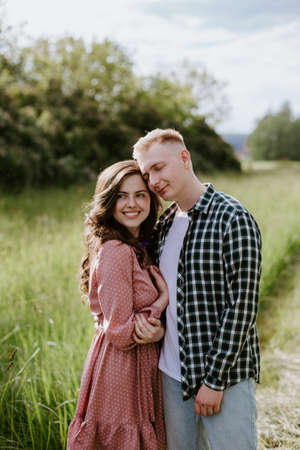 Happy young couple, a guy and a girl, look into the camera and smileの写真素材