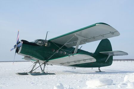 plane with skis on the snowの写真素材