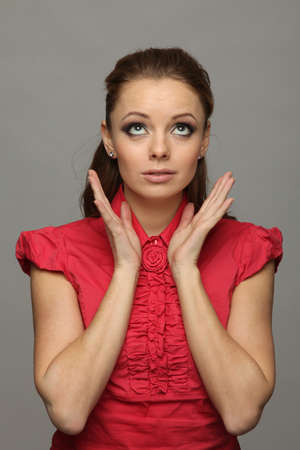 pretty red-haired girl looked up in surpriseの写真素材