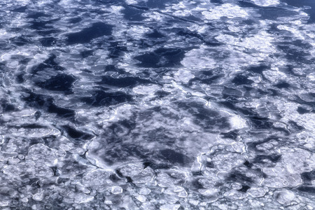 Blue sea surface with thin ice texture, background