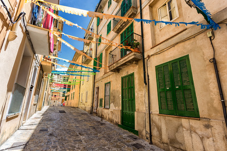 Old street of Palma de Mallorca with green doors and shuttersの写真素材