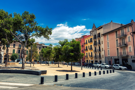 Square in Palma de Mallorca with colorful buildings and treesのeditorial素材