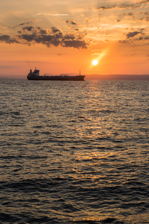 Beautiful sunset view over the sea and ship silhouetteの写真素材
