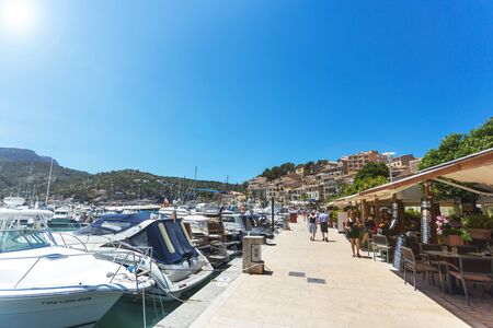 PORT DE SOLLER, SPAIN - JUNE, 2015: Yachts and restaurants of small town by the sea on Mallorca...