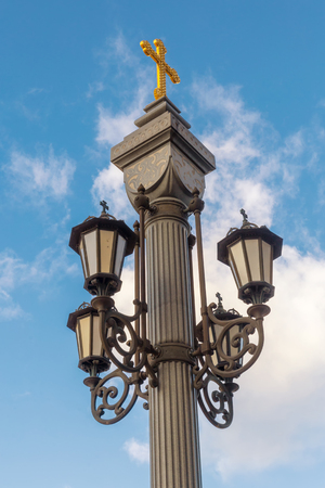 Street light with a golden cross on the top in Moscow city centerの写真素材