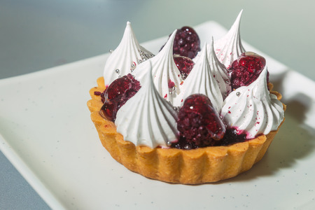 cream tart on a square white plateの写真素材