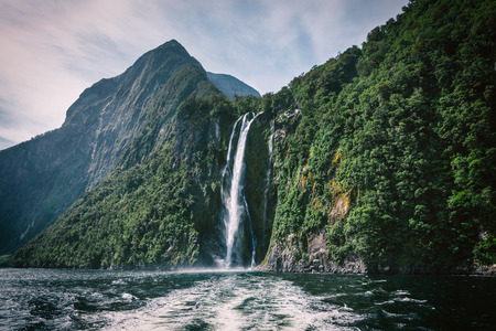 High waterfall in Milford Sound, picture taken from cruise ferry.の写真素材