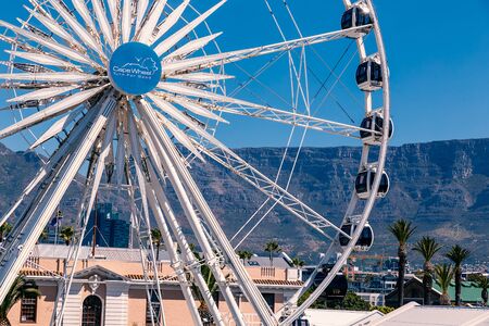 CAPE TOWN, SOUTH AFRICA - NOVEMBER, 2018: Ferris wheel and Table Mountain view at Waterfront in Cape Townのeditorial素材