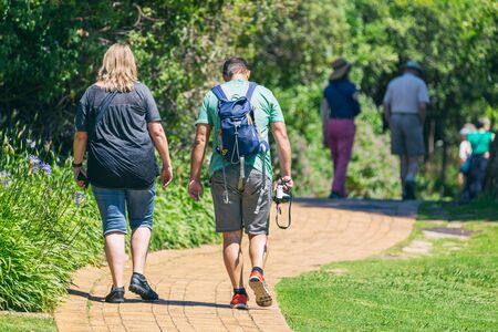 CAPE TOWN, SOUTH AFRICA - NOVEMBER, 2018: Tourists on walking trail in Kirstenbosch botanical...