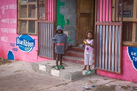 CAPE TOWN, SOUTH AFRICA - NOVEMBER, 2018: Local african kids near the store in township in South...
