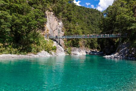 OTAGO, NEW ZEALAND - DECEMBER, 2017: People jumping from the bridge into beautiful turquoise water at Blue Pools, South island of New Zealandのeditorial素材