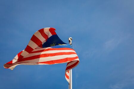 Waving flag of Malaysia and blue sky backgroundの写真素材