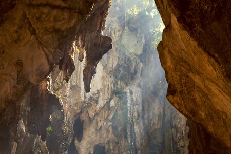 Sunlight shining through the rocks of famous Batu Caves in Kuala Lumpurの写真素材