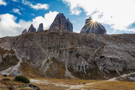 Stunning view of rocky mountains and cloudy sky in Tre Cime di Lavaredo park in Italyの写真素材