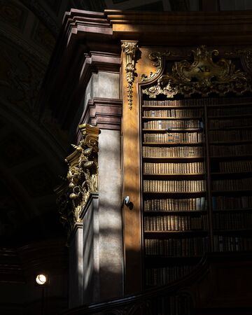 Bookshelves in the dark in old historical library in europe