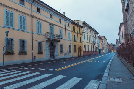 Old empty street early morning view in Ravenna, Italyの写真素材