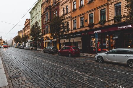 PRAGUE, CZECH REPUBLIC - OCTOBER, 2019: Streets of Prague historical center with shops, cars and red tramのeditorial素材
