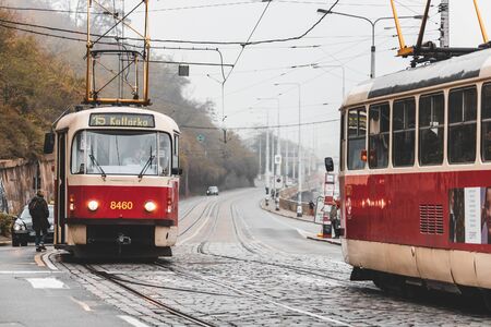 PRAGUE, CZECH REPUBLIC - OCTOBER, 2019: Red trams on Prague city roadsのeditorial素材