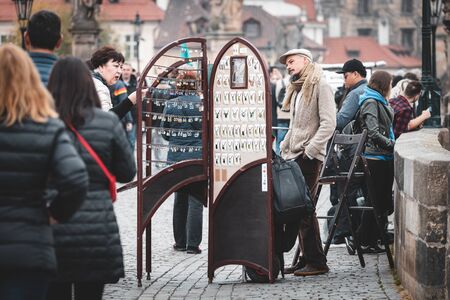 PRAGUE, CZECH REPUBLIC - OCTOBER, 2019: People selling jewelry on Charles Bridge, most famous...