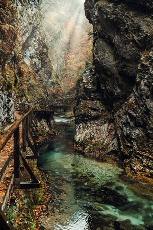 Famous Vintgar Gorge with rocky banks of the river and wooden pedestrian bridge in autumn season, Sloveniaの写真素材