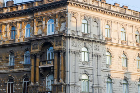 Contrast on the building in Budapest - one part of the house is renewed, the other is old and uglyのeditorial素材