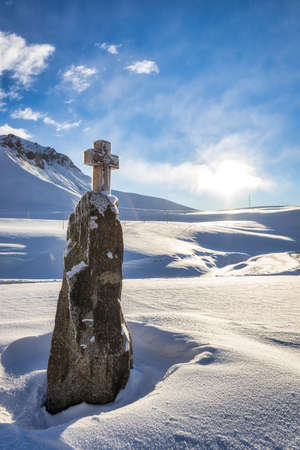 Cross monument on Georgian military road and fresh snowの写真素材