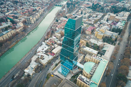 Aerial view of Tbilisi city center with churches and modern buildings and emerald waters of Kura riverのeditorial素材