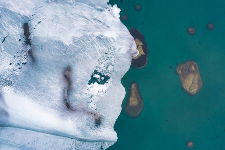 Ice floes and emerald sea water in early spring top aerila viewの写真素材