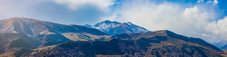 Panorama view of mountains covered with snow in Kyrgyzstanの写真素材