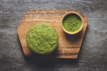 Matcha cookies with macadamia nuts and white chocolate chips on a dark wooden tableの写真素材