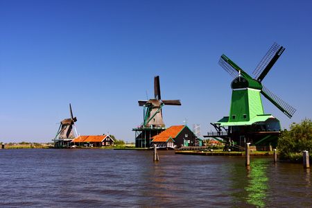 Three wind mills on lakeの写真素材