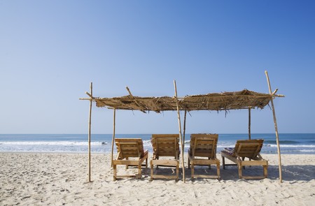 chairs and umbrella at a tropical beach. place for textの写真素材