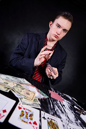 a poker player sitting at a table trying to hide his expressionsのeditorial素材