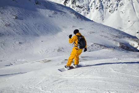Snowboarder looking down the slope. Sunny dayの写真素材