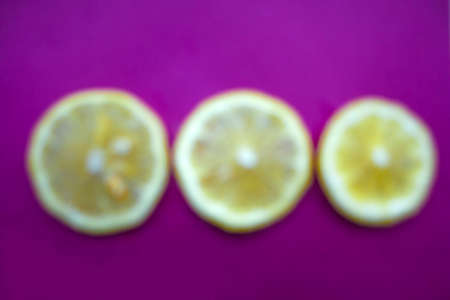 blurred lemon slices on a purple backgroundの写真素材