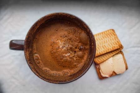 Cup of cappuccino and biscuits with butter on a white backgroundの写真素材