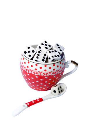 ceramic polka dot Cup with dice and ceramic polka dot spoon and dice on white backgroundの写真素材