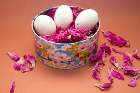 Easter card: eggs in a metal box with leaves of a peony