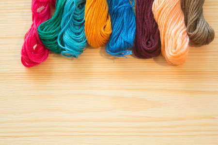 embroidery floss on wooden background. handmade conceptの写真素材