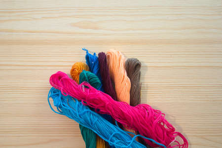 embroidery floss on wooden background. handmade conceptの写真素材